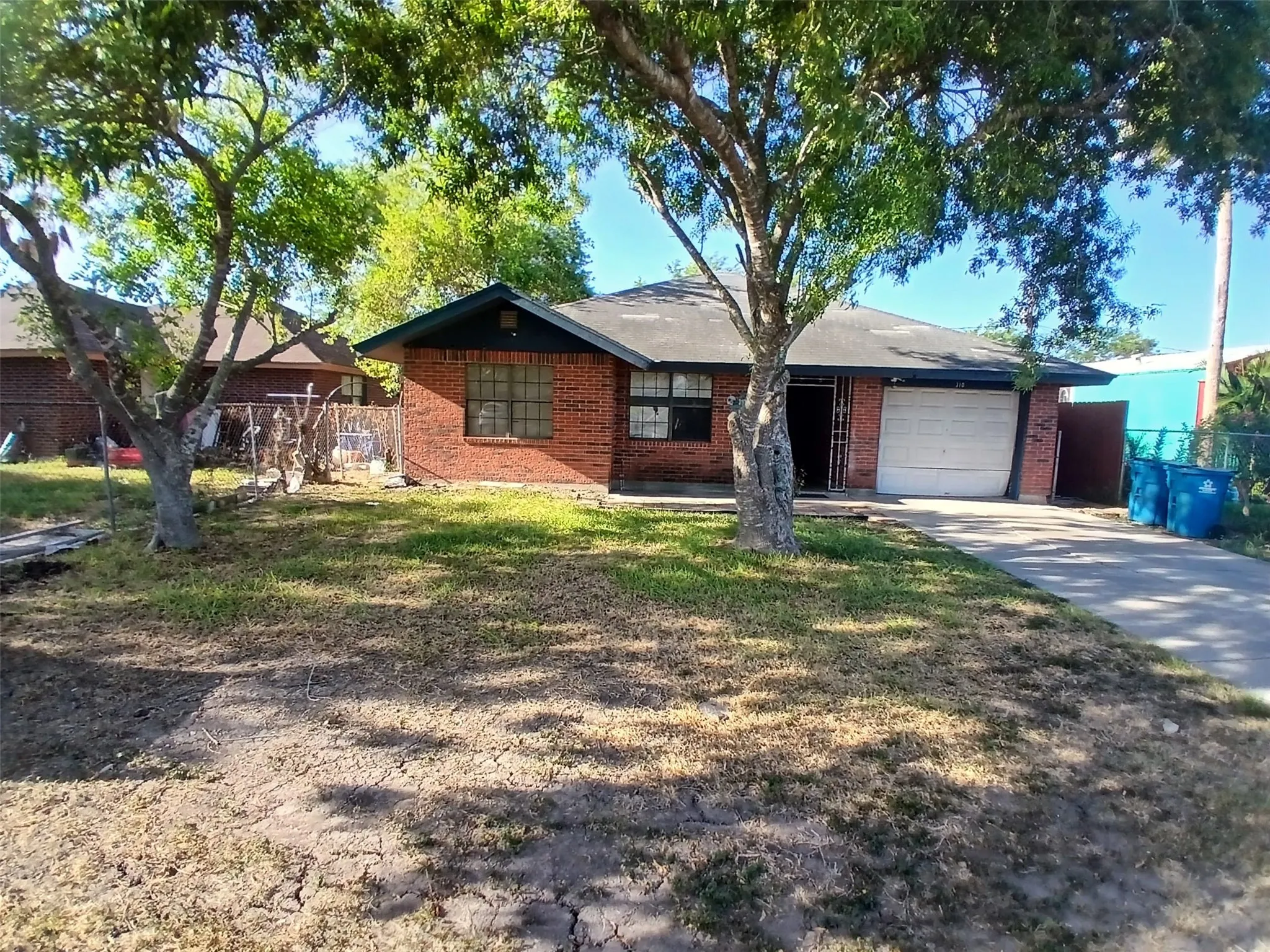 Brick exterior with a single-car garage and a concrete driveway