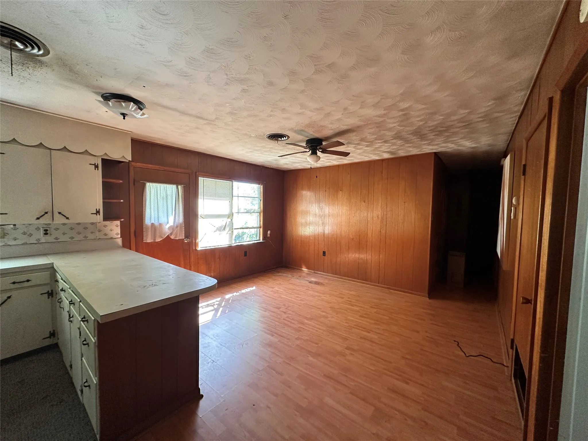 wood paneling, white built-in cabinetry, and white countertops