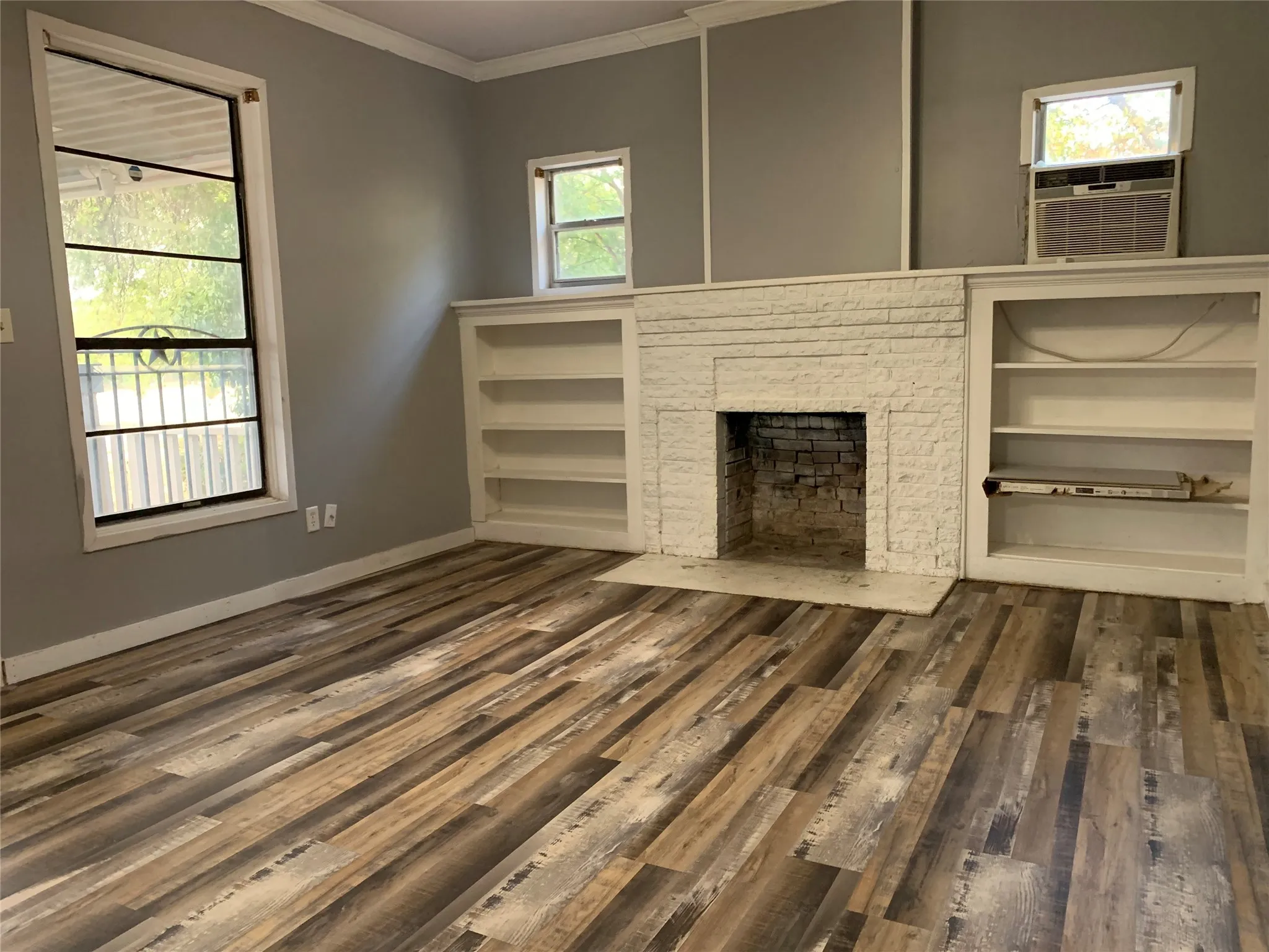 New Paint in the living room and flooring. Built in shelves with a decorative fireplace makes for a cozy space.