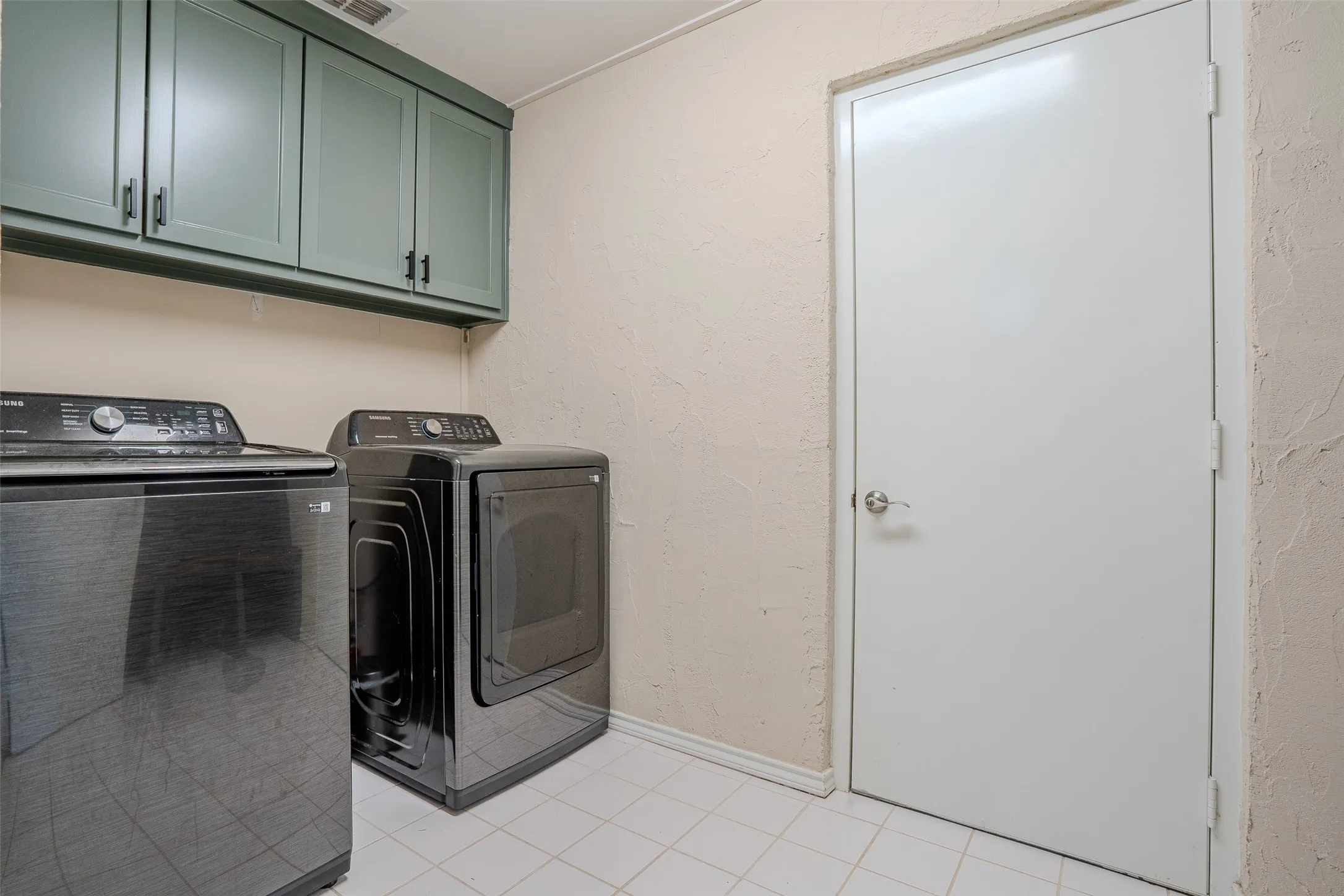 Upper cabinetry with dark hardware