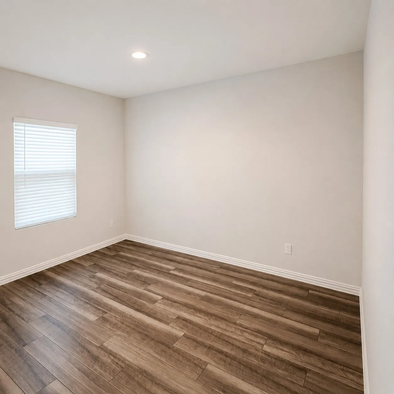 Recessed ceiling lighting, wood-finish flooring, white baseboards, and a window with blinds