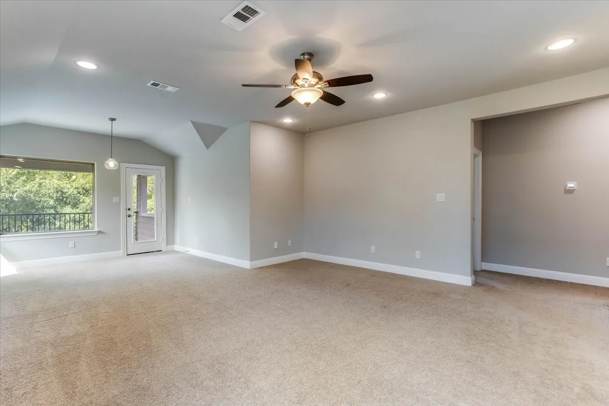 Living and flex room on second floor with recess lighting, neutral carpet, and balcony to enjoy the outdoors in comfort.