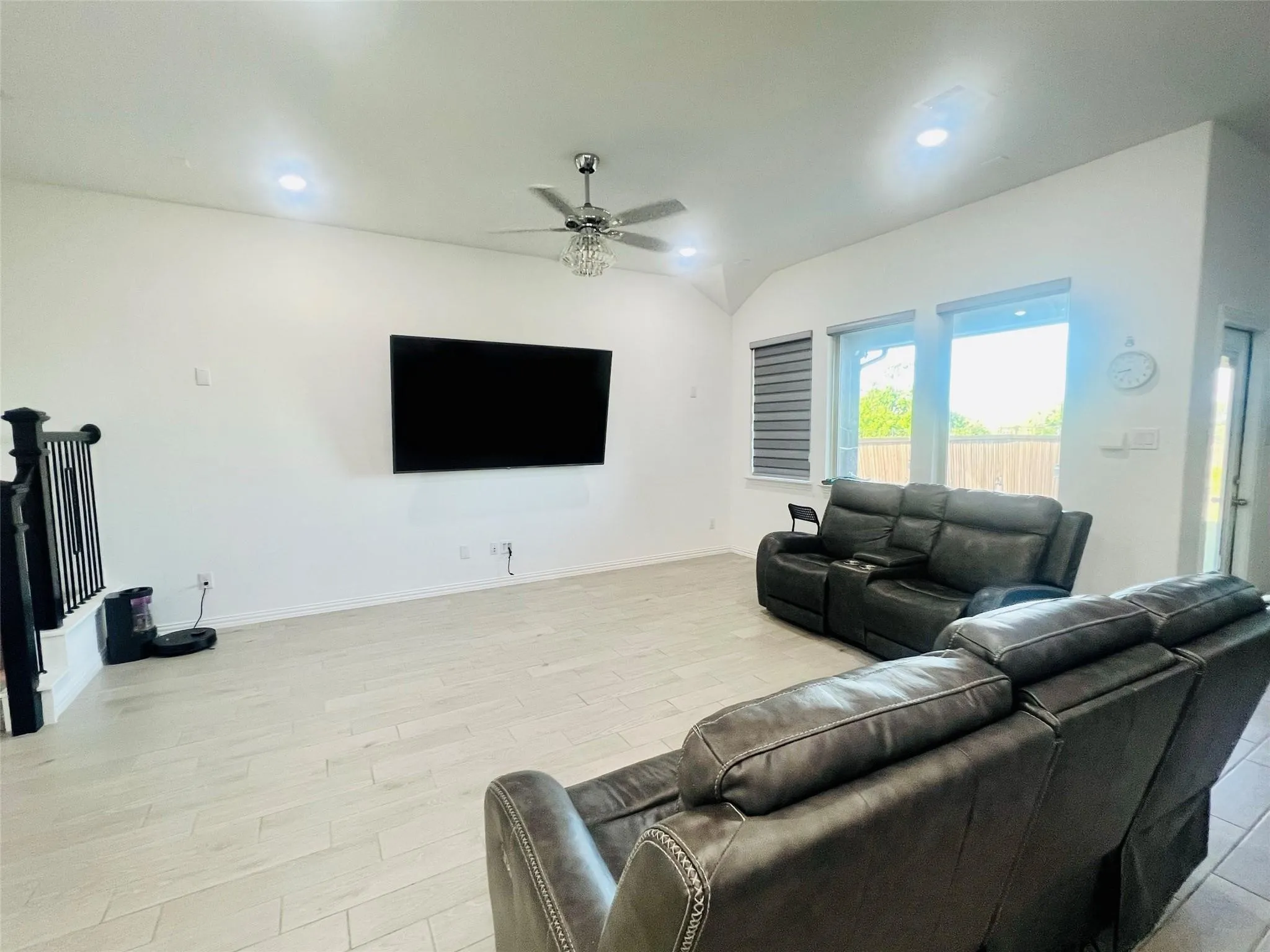 Wood-finish flooring, recessed lighting, and a contemporary ceiling fan with an integrated light fixture