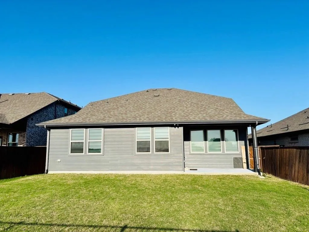 Expansive lawn with a wood fence perimeter