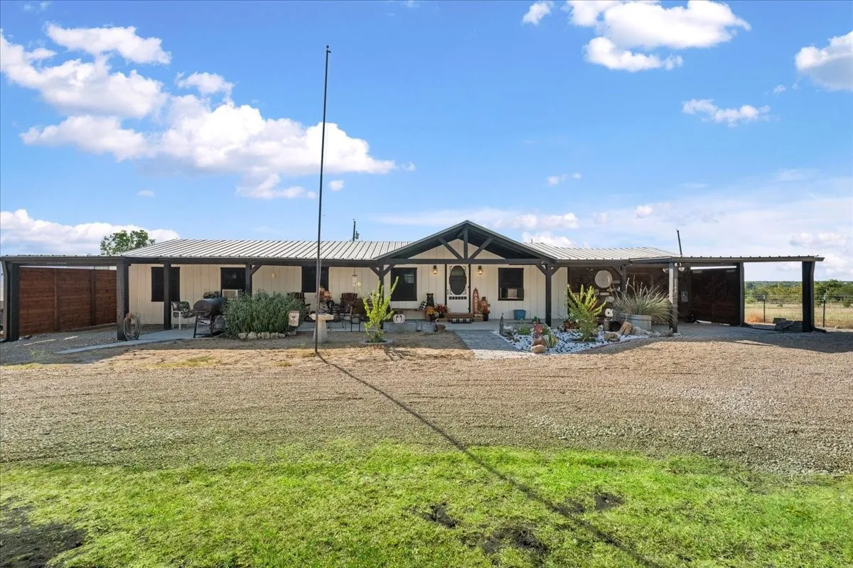 Single-story residence with a covered front porch and a metal roof