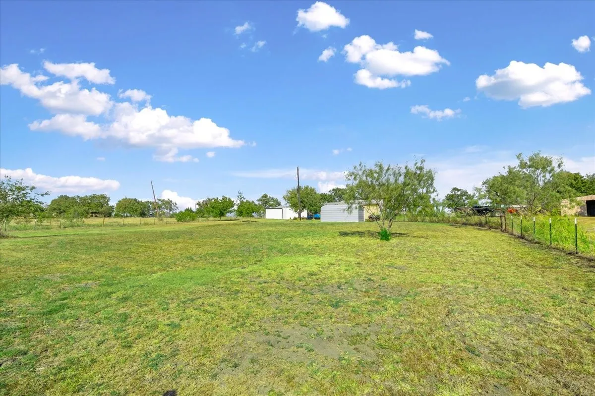 Expansive open lot with a partial wire fence