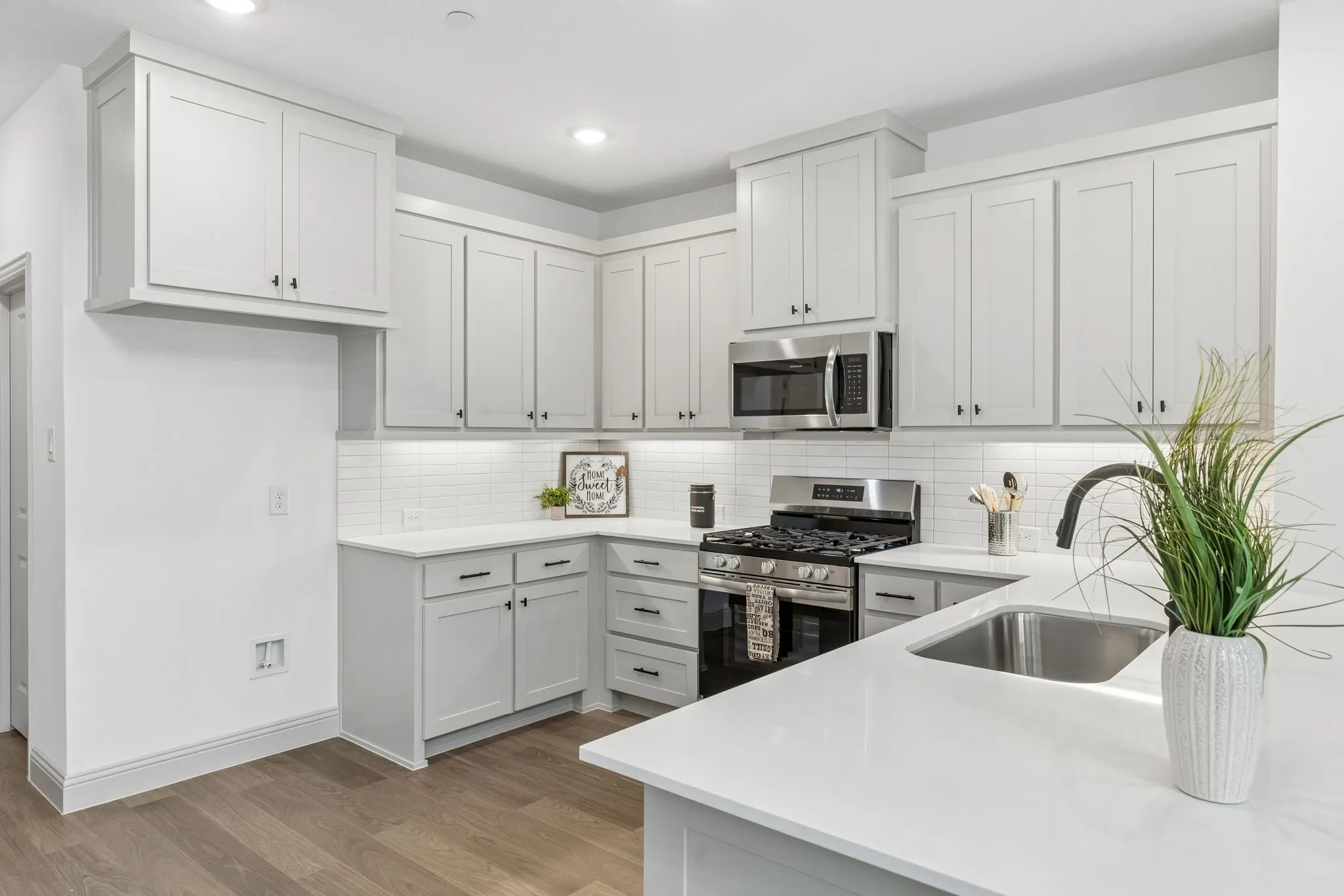 The kitchen peninsula does double duty as the perfect place for a quick family meal or homework station!