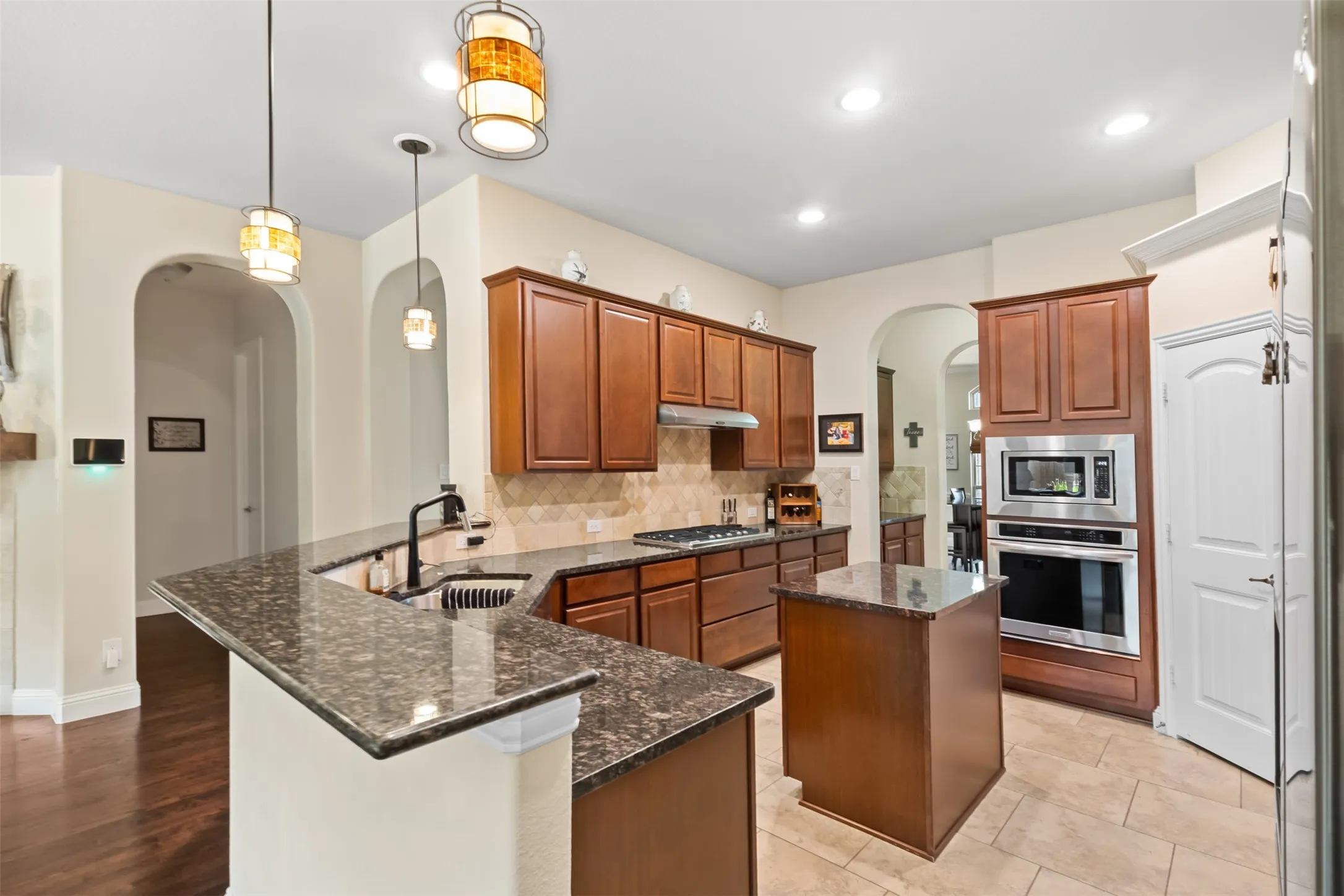 Wood-finish cabinetry with stainless steel appliances
