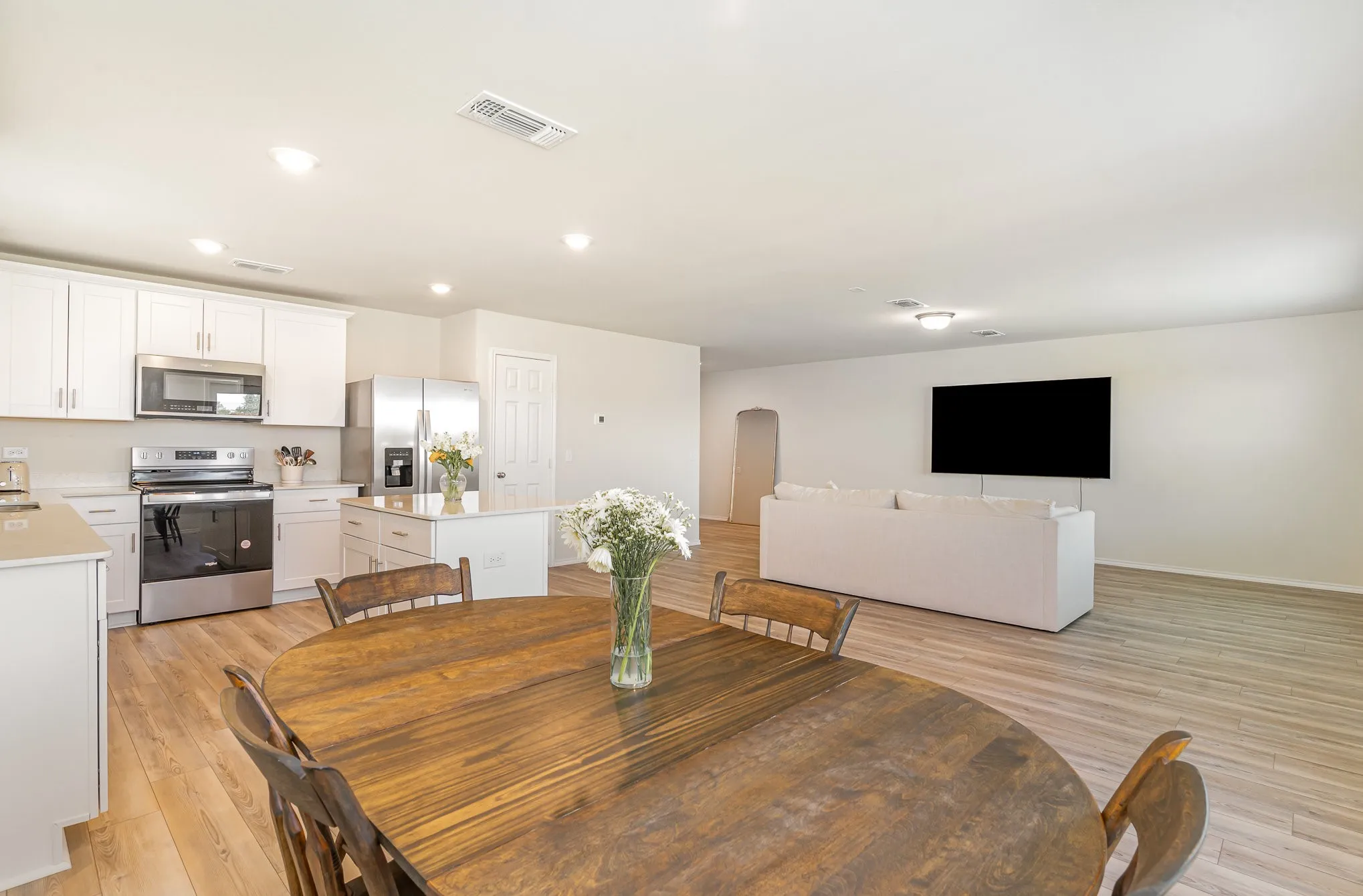 Open-concept living area featuring wood-finish flooring