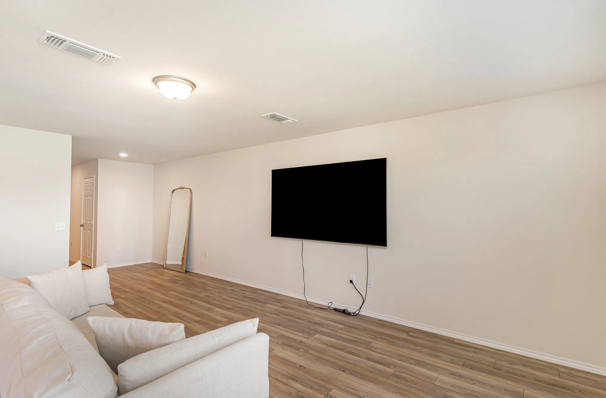 Neutral wall tones with wood-finish flooring