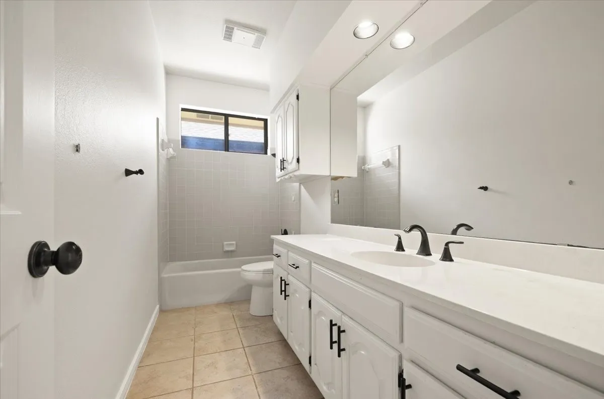 Dual vanity with integrated sinks and black-finish hardware