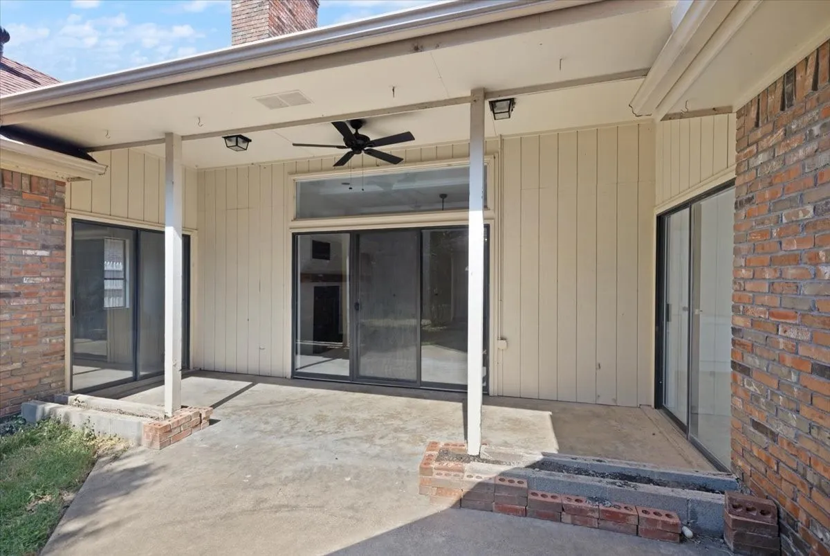 Covered patio featuring a ceiling fan, recessed lighting, and brick accents