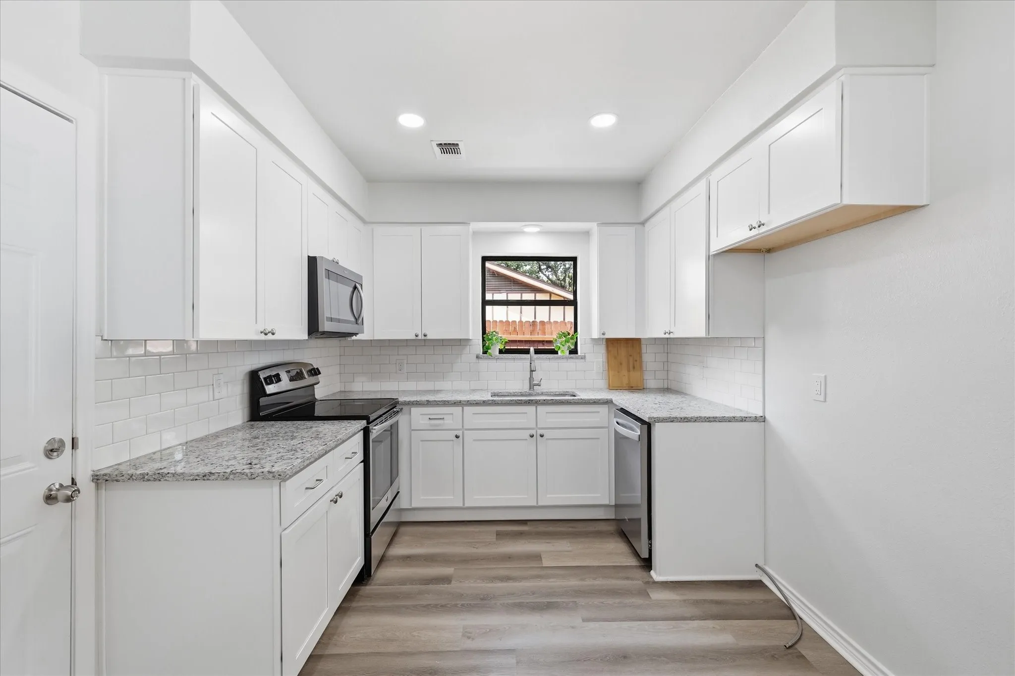 Kitchen has granite tops, new soft closing cabinets, Lg. sink, subway splash & stainless steel appliances.