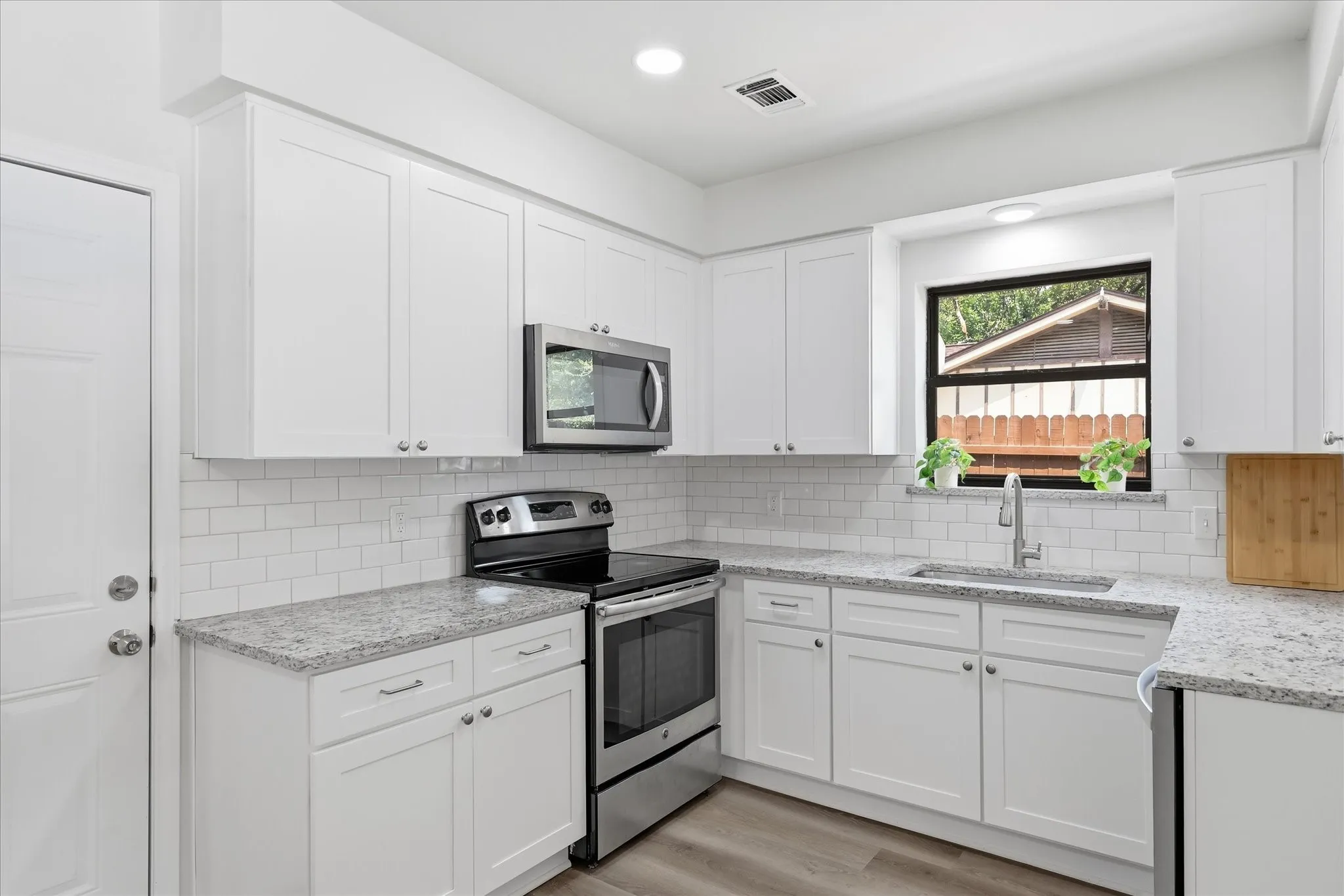 Kitchen has granite tops, new soft closing cabinets, Lg. sink, subway splash & stainless steel appliances.