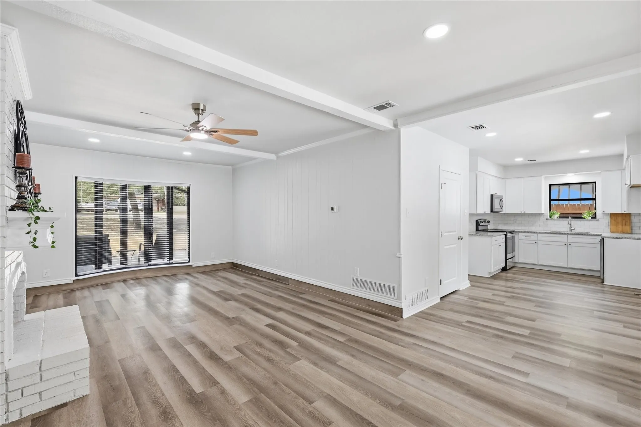 Living Rm is open & light with WBFP, Bay window, & open to the Brk area & pool view.
