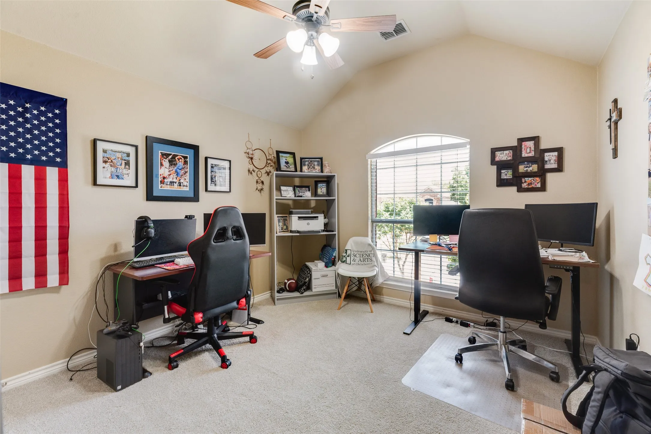 Vaulted ceiling with a ceiling fan, arched window with horizontal blinds, and neutral carpet flooring