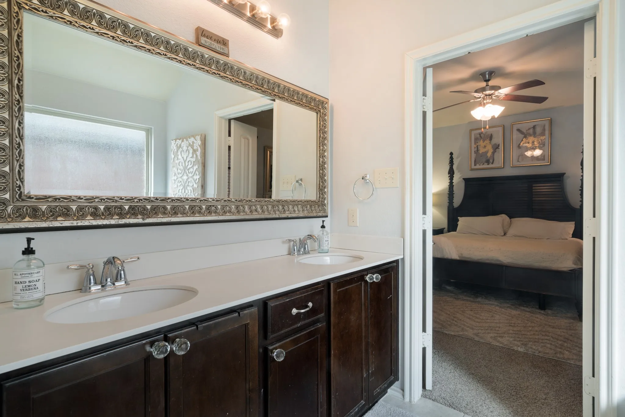 Dual vanity with undermount sinks, chrome fixtures, and dark wood-finish cabinetry