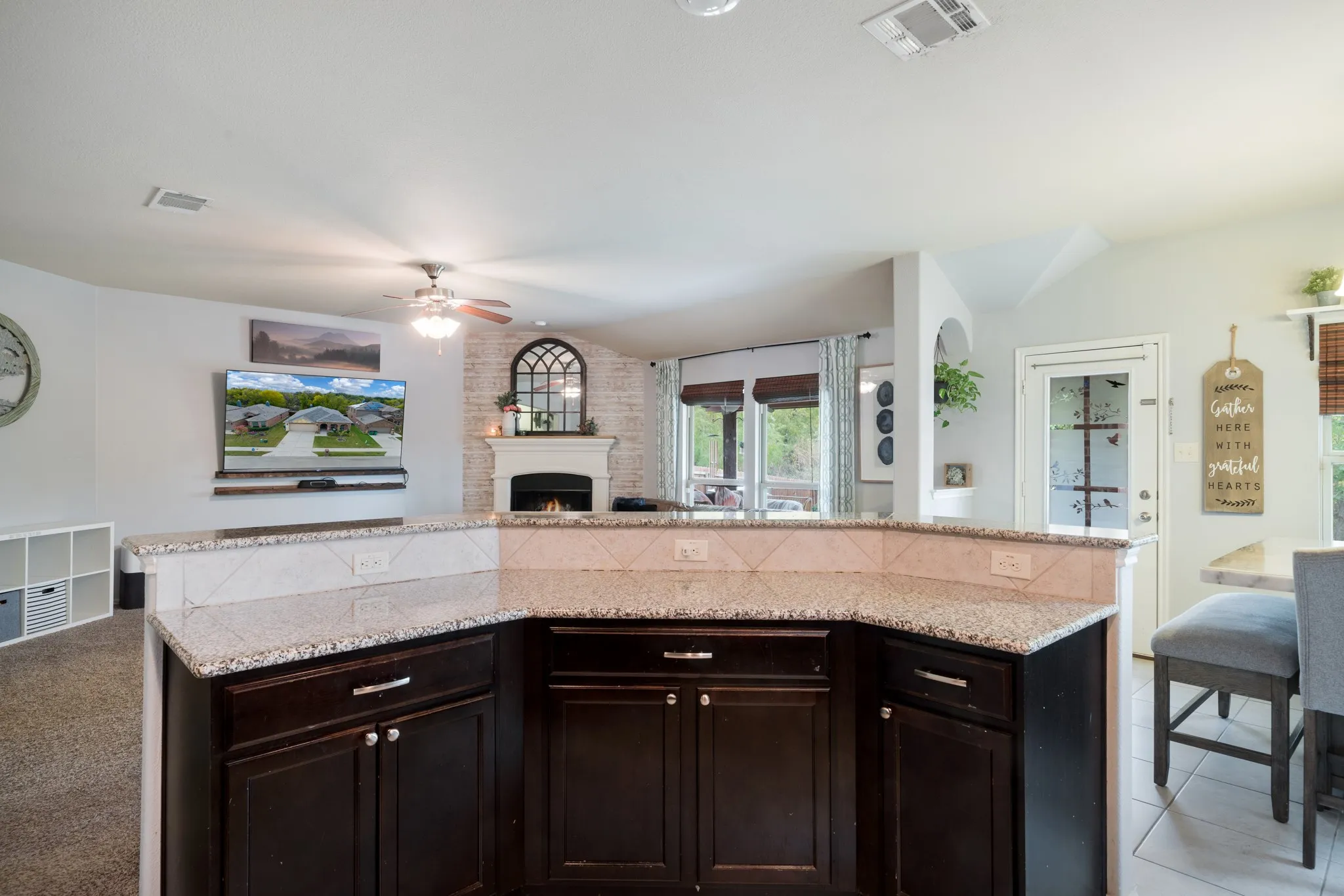 Kitchen island with dark wood cabinetry and granite countertops