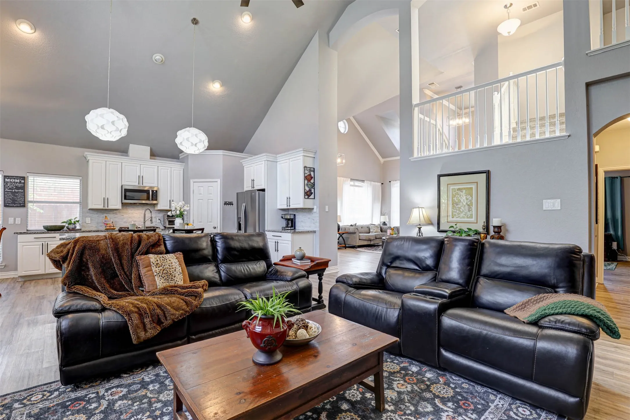 The family room's high windows and open layout connect effortlessly to the kitchen and breakfast area — ideal for everyday living and entertaining.