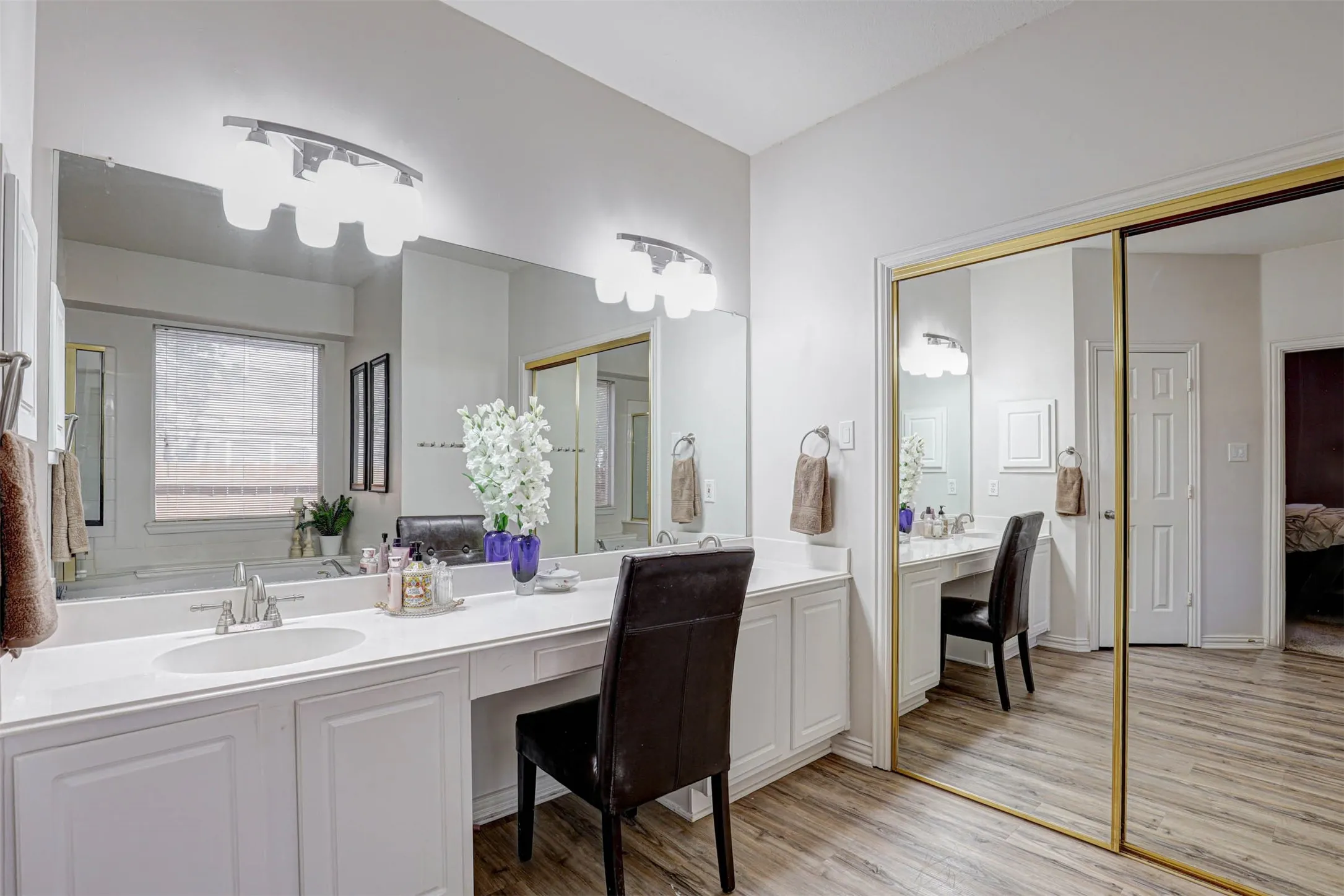 The ensuite bath features dual sinks and a dedicated makeup vanity, combining elegance and everyday practicality.