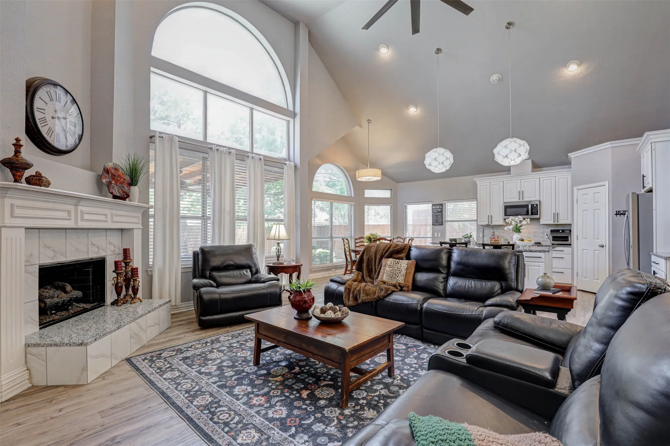 Soaring windows flood the family room with natural light, with an easy open flow into the kitchen and breakfast area.