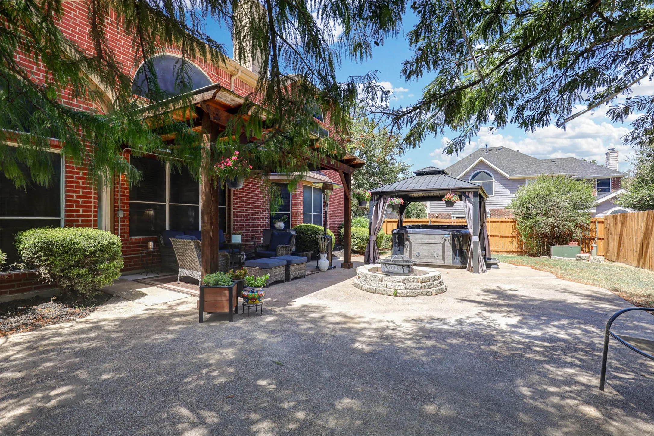 The expansive backyard offers plenty of room to play, garden, or add a pool, with a beautiful back elevation and covered patio.