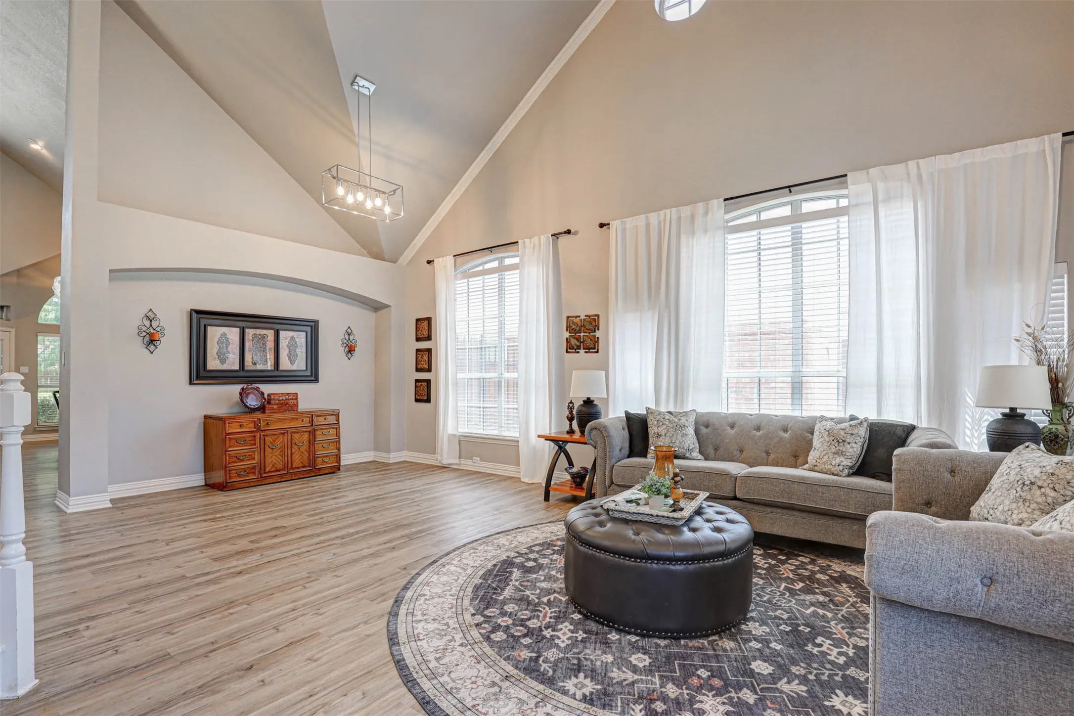 Bright and airy living space filled with natural light and impressive ceiling details throughout.