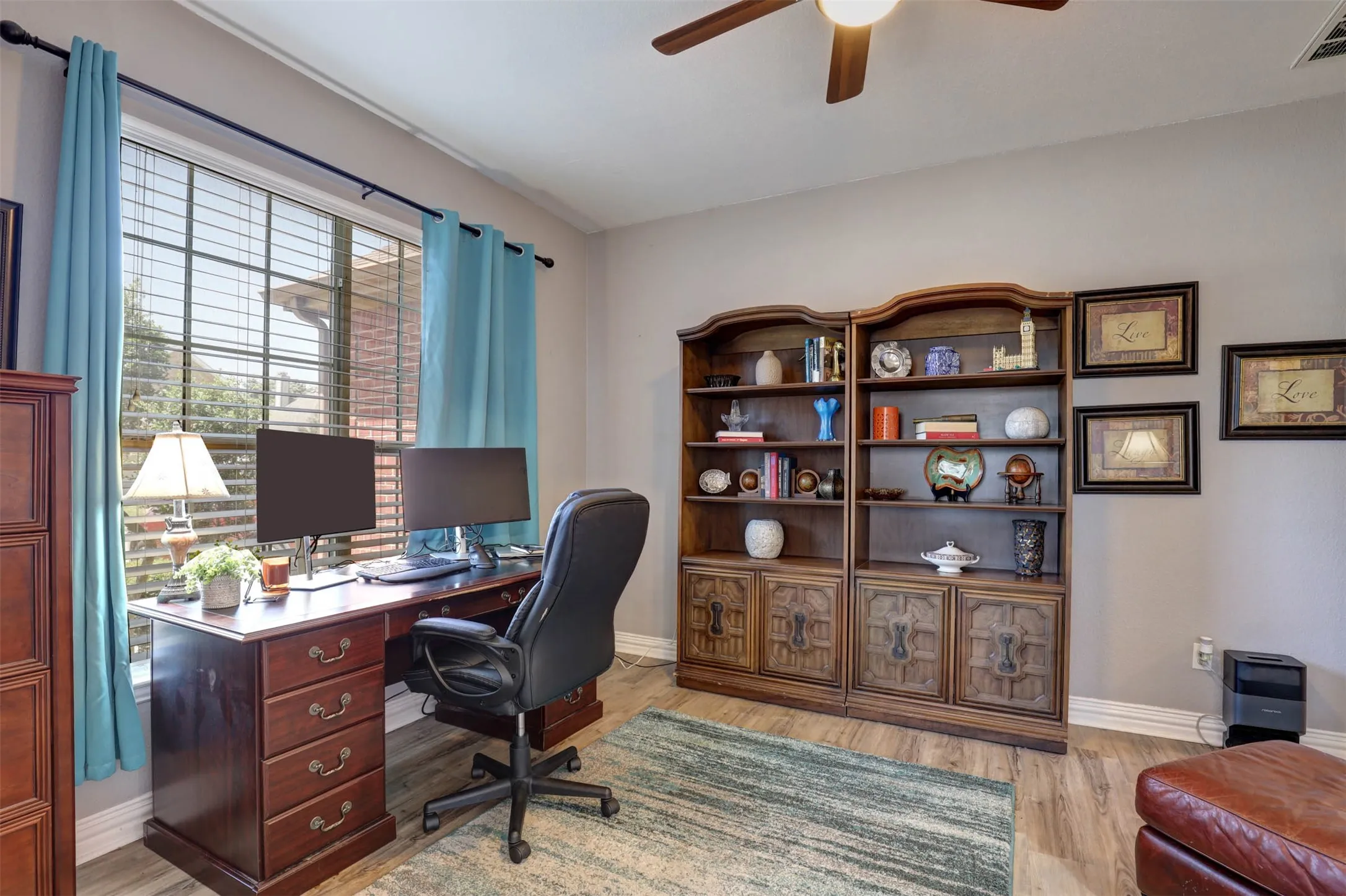The office offers a quiet, dedicated workspace with a ceiling fan and ample natural light.