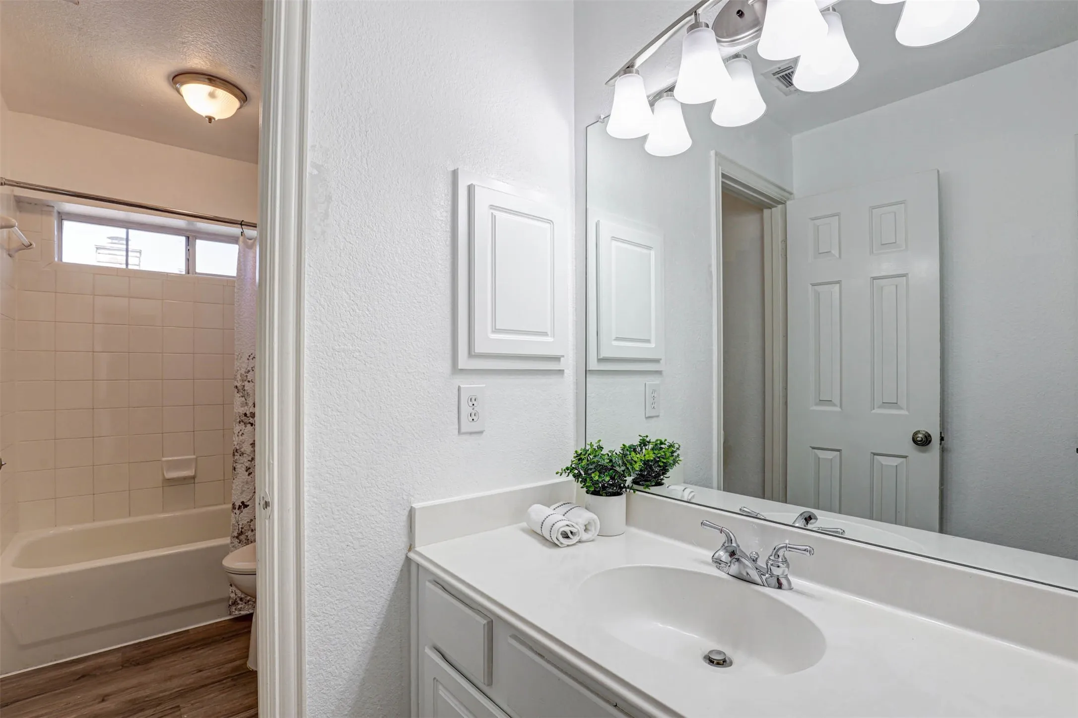 The second vanity opens to the hallway, providing easy access for guests and the adjacent bedroom.