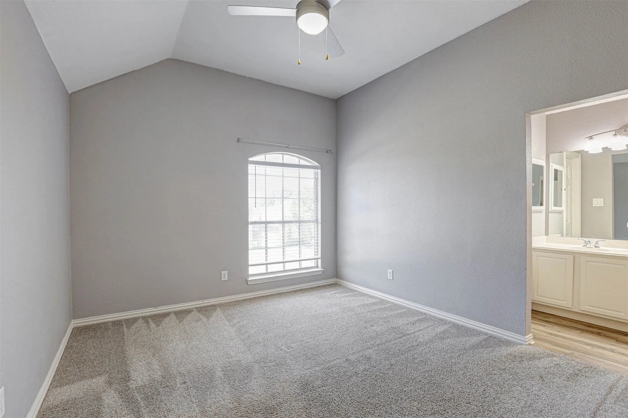 This upstairs bedroom features convenient access to the dual-entry bath, with a shared wet area and its own separate vanity