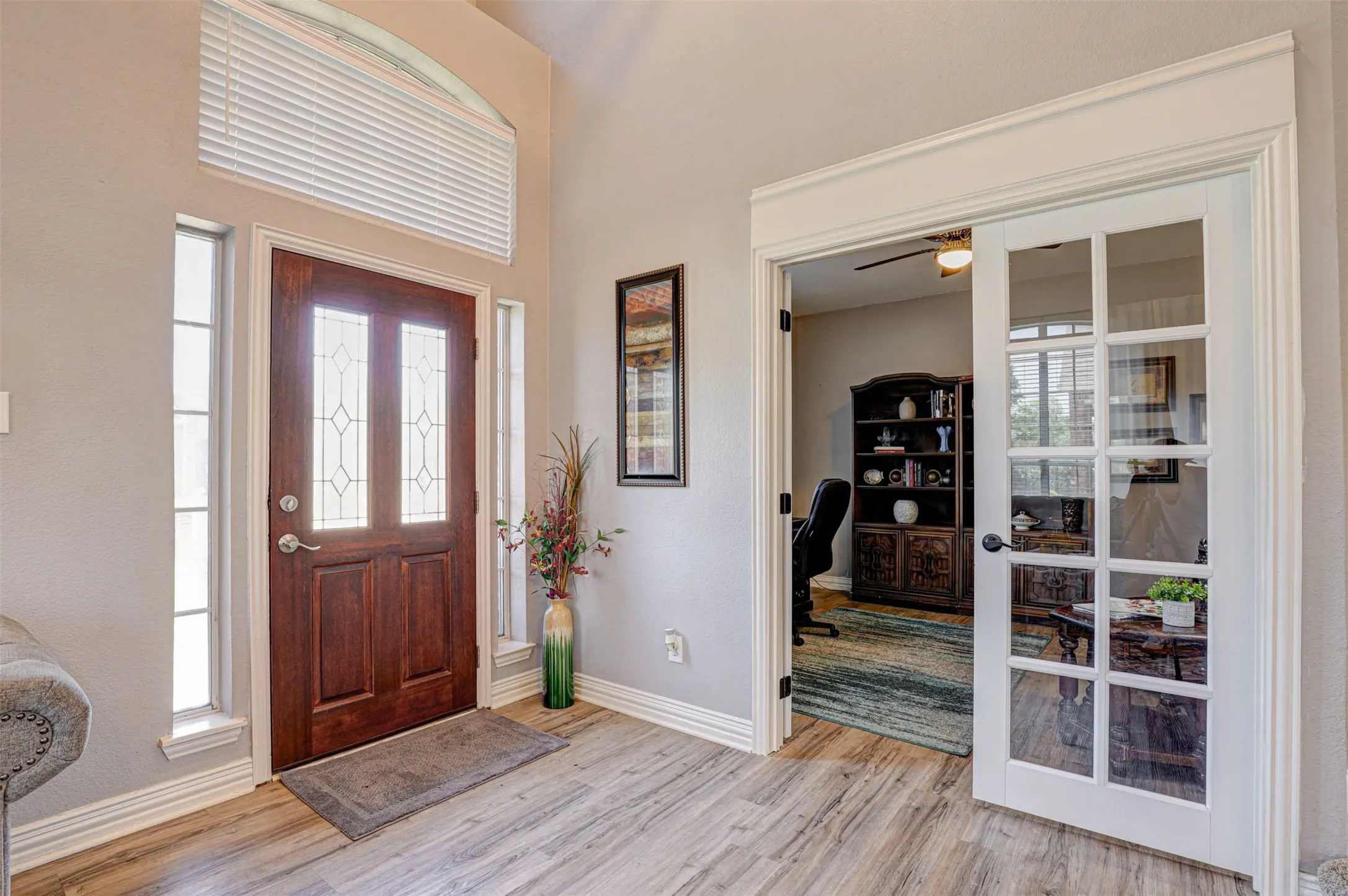 A welcoming entry that opens directly to the home office with elegant French double doors.