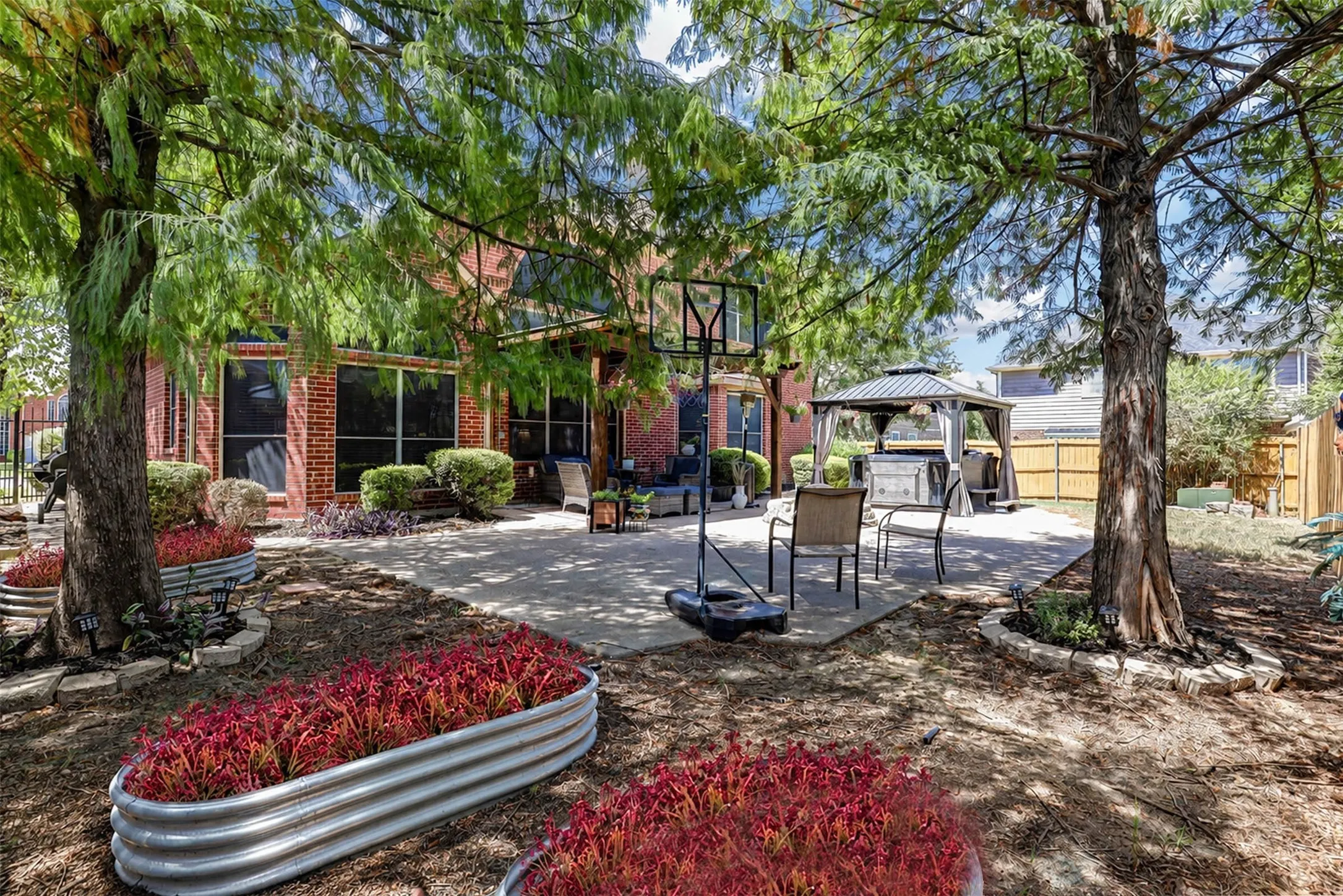 Enjoy a backyard designed for year-round living. The beautiful, treed yard leaves space for multiple types of outdoor activities.