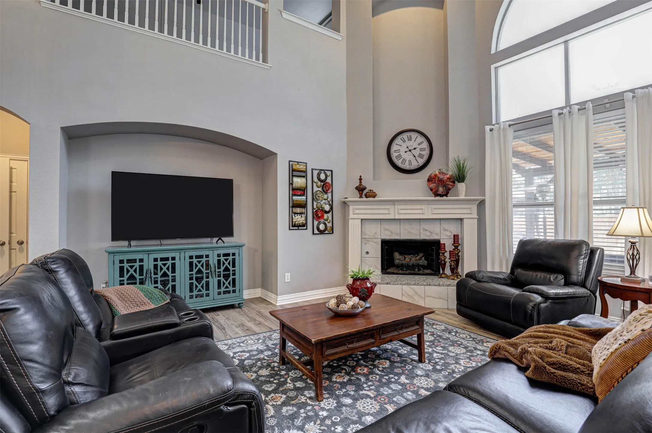 The cozy corner fireplace with beautiful tile surround makes this family room the perfect gathering spot.