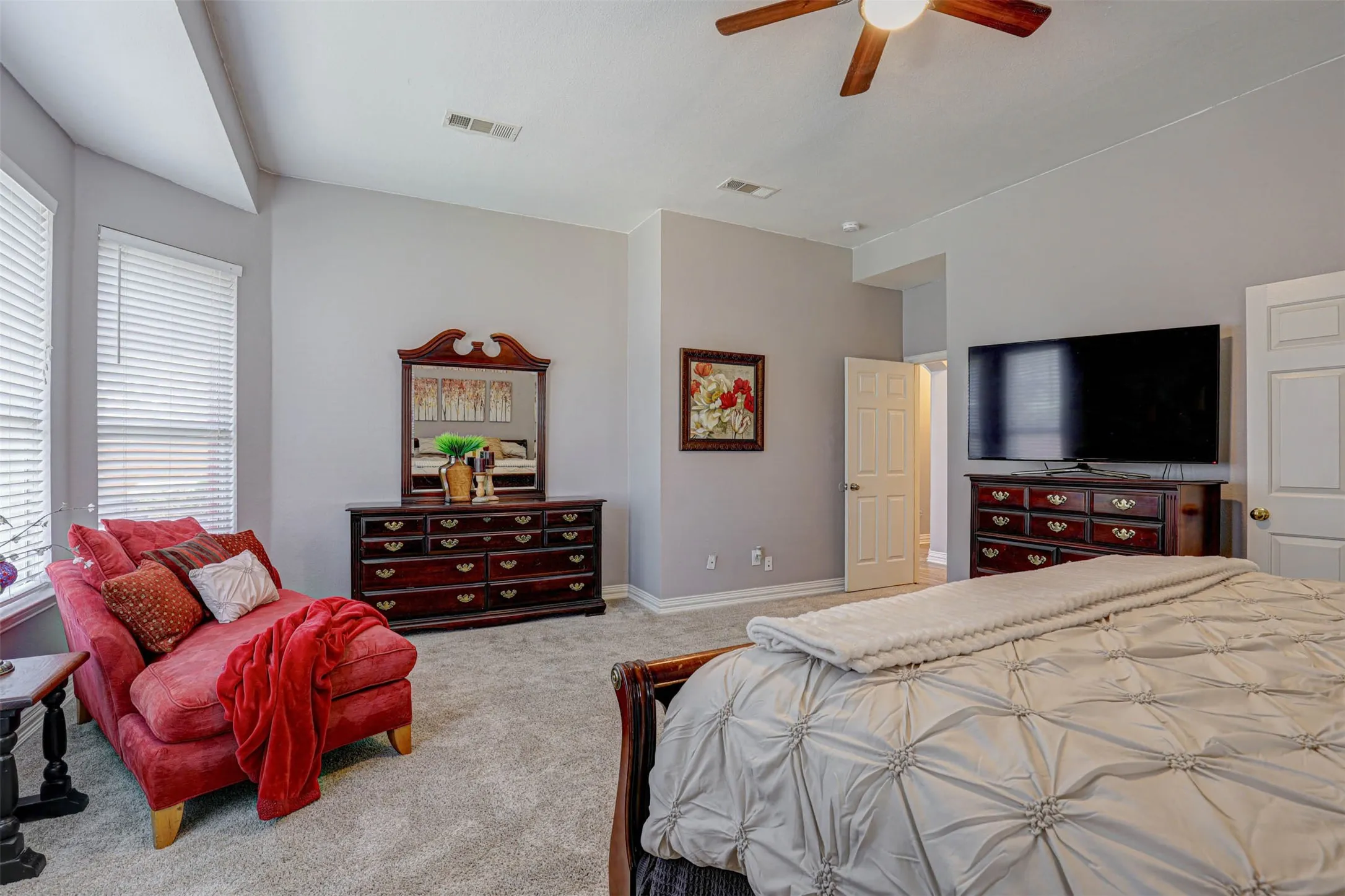 The primary bedroom's sitting area and bay window create a quiet, relaxing escape overlooking the backyard.