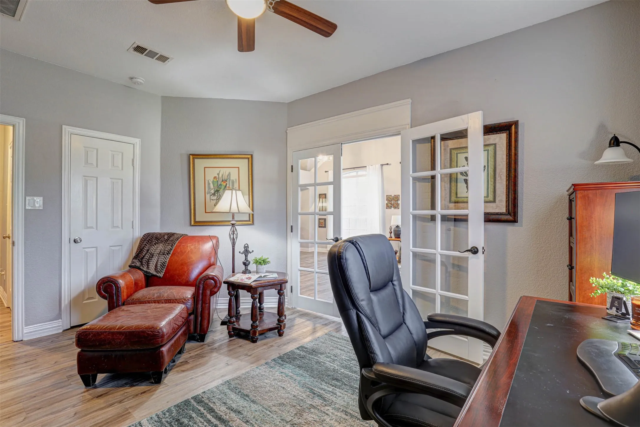 A beautifully appointed home office with elegant French double doors — stylish, functional, and perfectly situated on the first floor.
