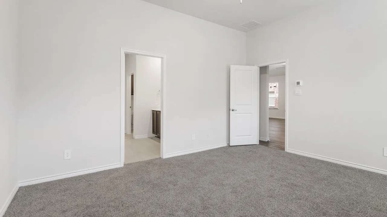 Neutral wall finishes, recessed ceiling detail, gray carpet flooring, white interior doors, and white trim