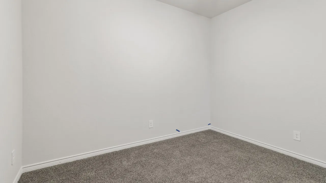Textured white walls with white trim and grey carpet