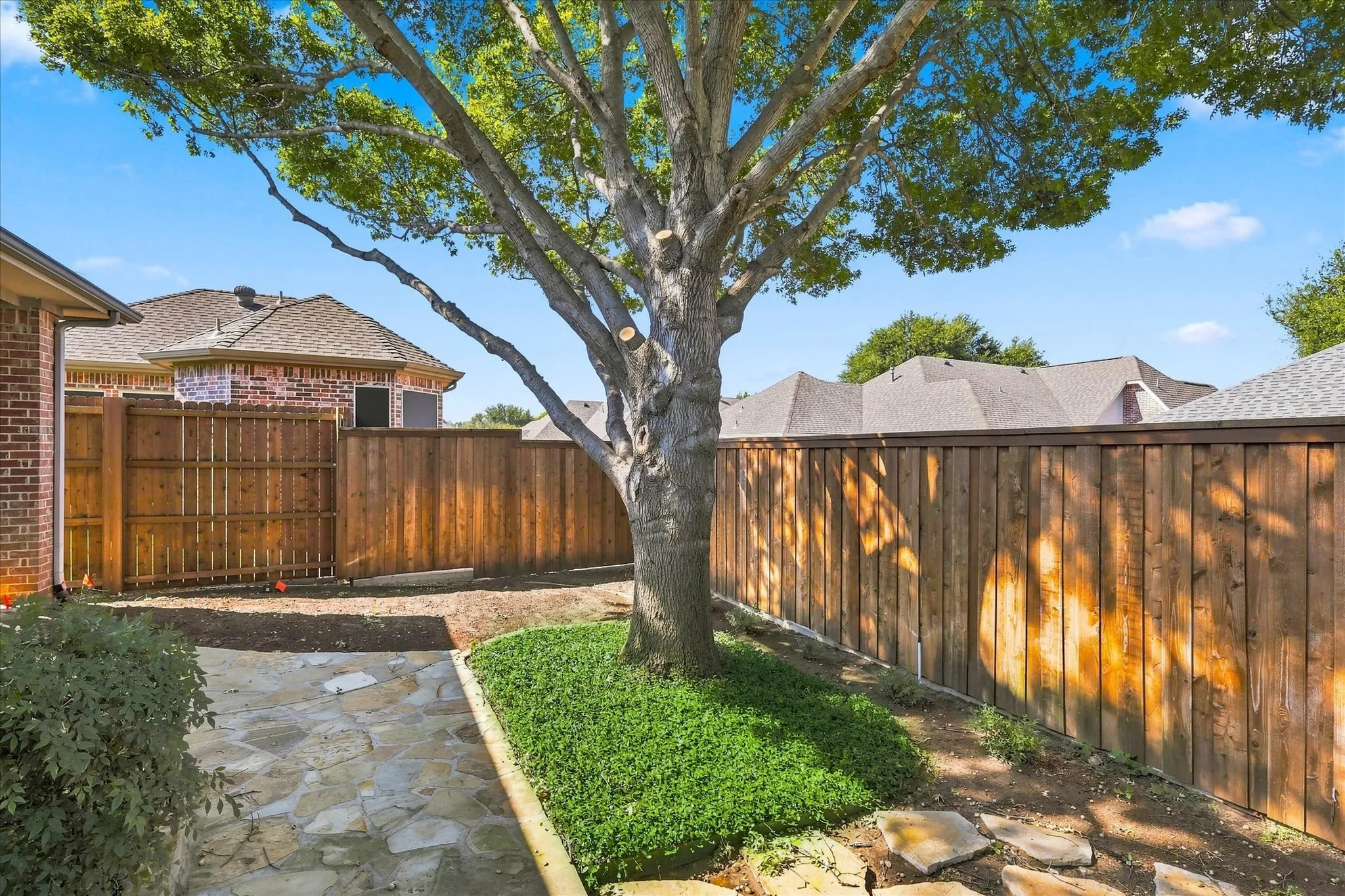 View from driveway gate. Beautiful flagstone paved path and board on board fence