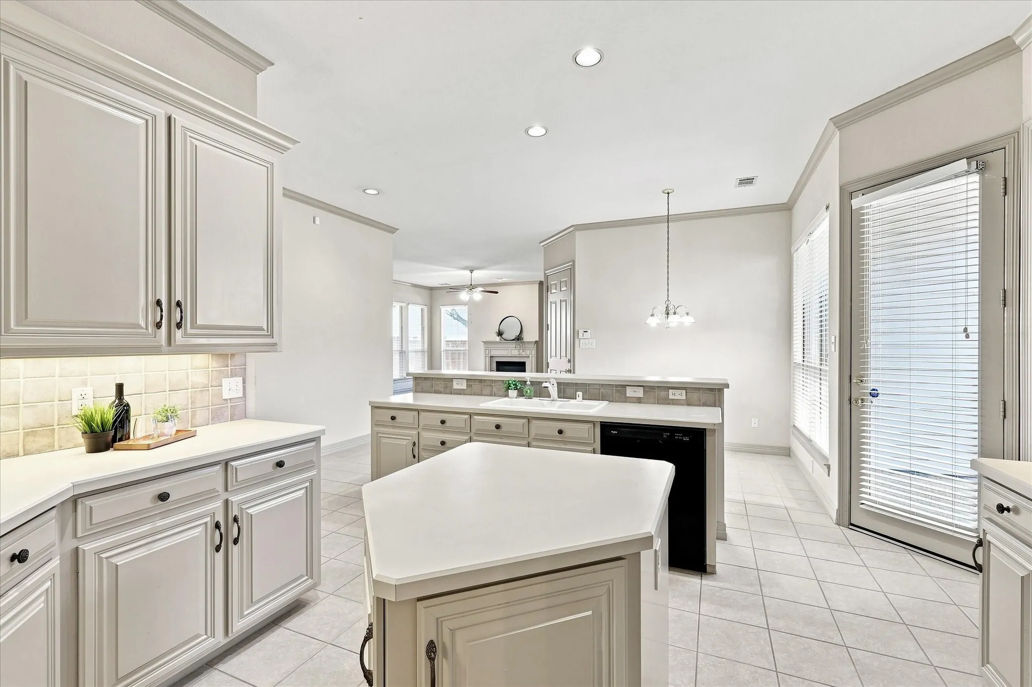 View from kitchen to breakfast room and into family room. Courtyard patio access from kitchen.