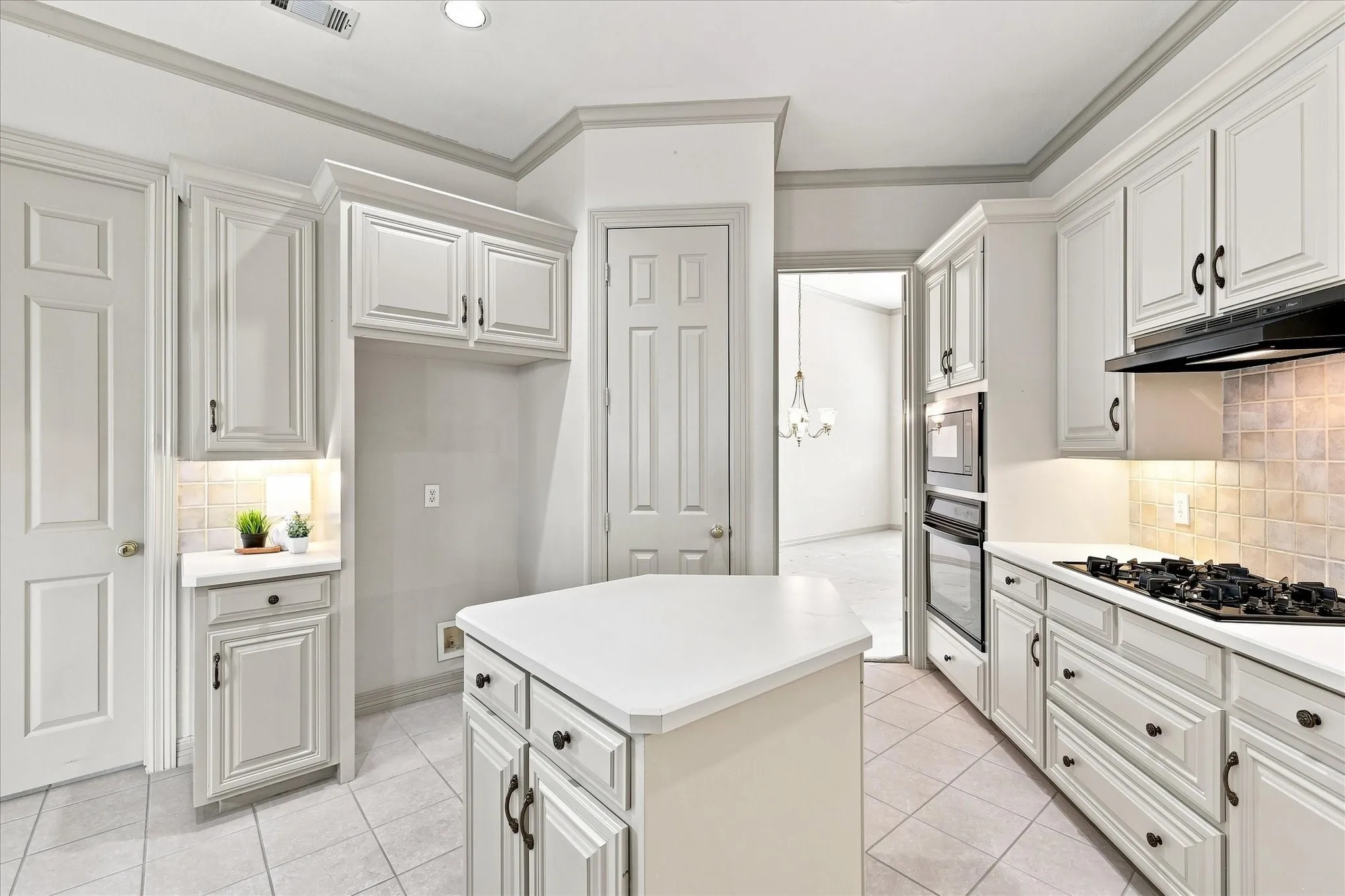 Handsome cabinets with taupe paint provide ample storage