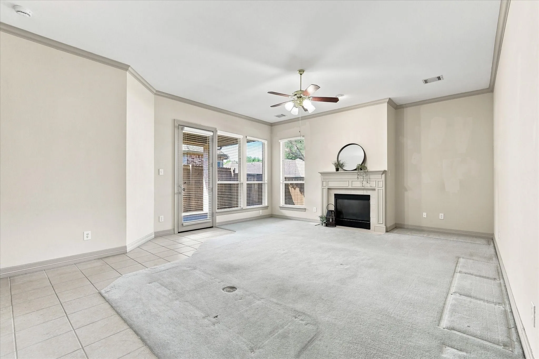 With fireplace and view to covered patio and backyard