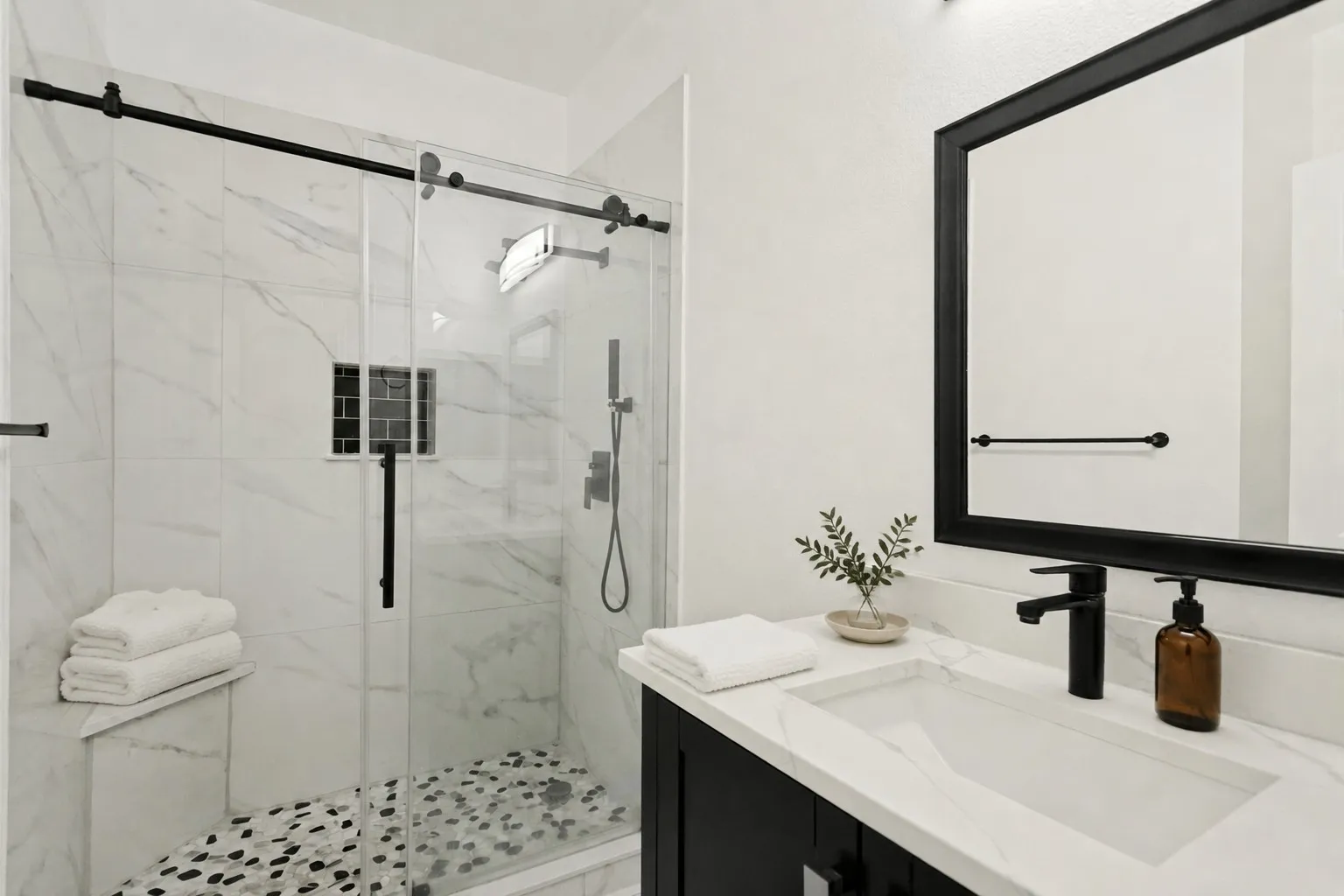 Modern bathroom featuring a vanity with an integrated sink, black-framed mirror, and matte black fixtures