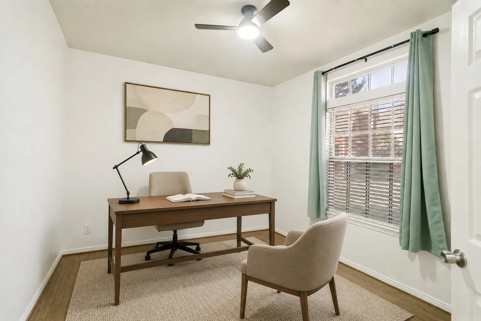 White walls, wood-finish flooring, and a ceiling fan with integrated lighting