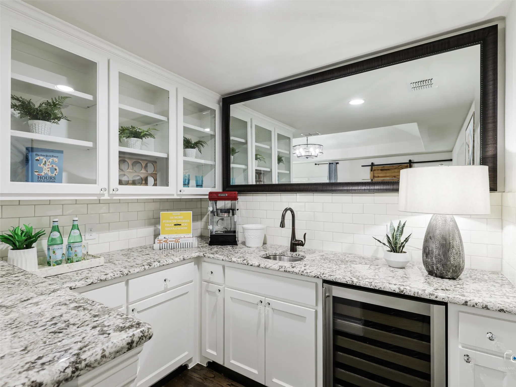 Wet bar with lots of cabinets and shelving.