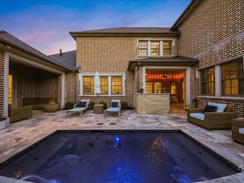 Pool with water features, sun decking and outdoor kitchen