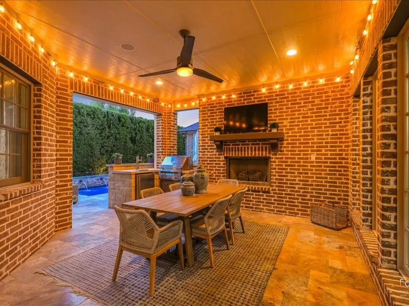 Patio with fireplace, outdoor kitchen with 2 taps, built in grill and outdoor lighting