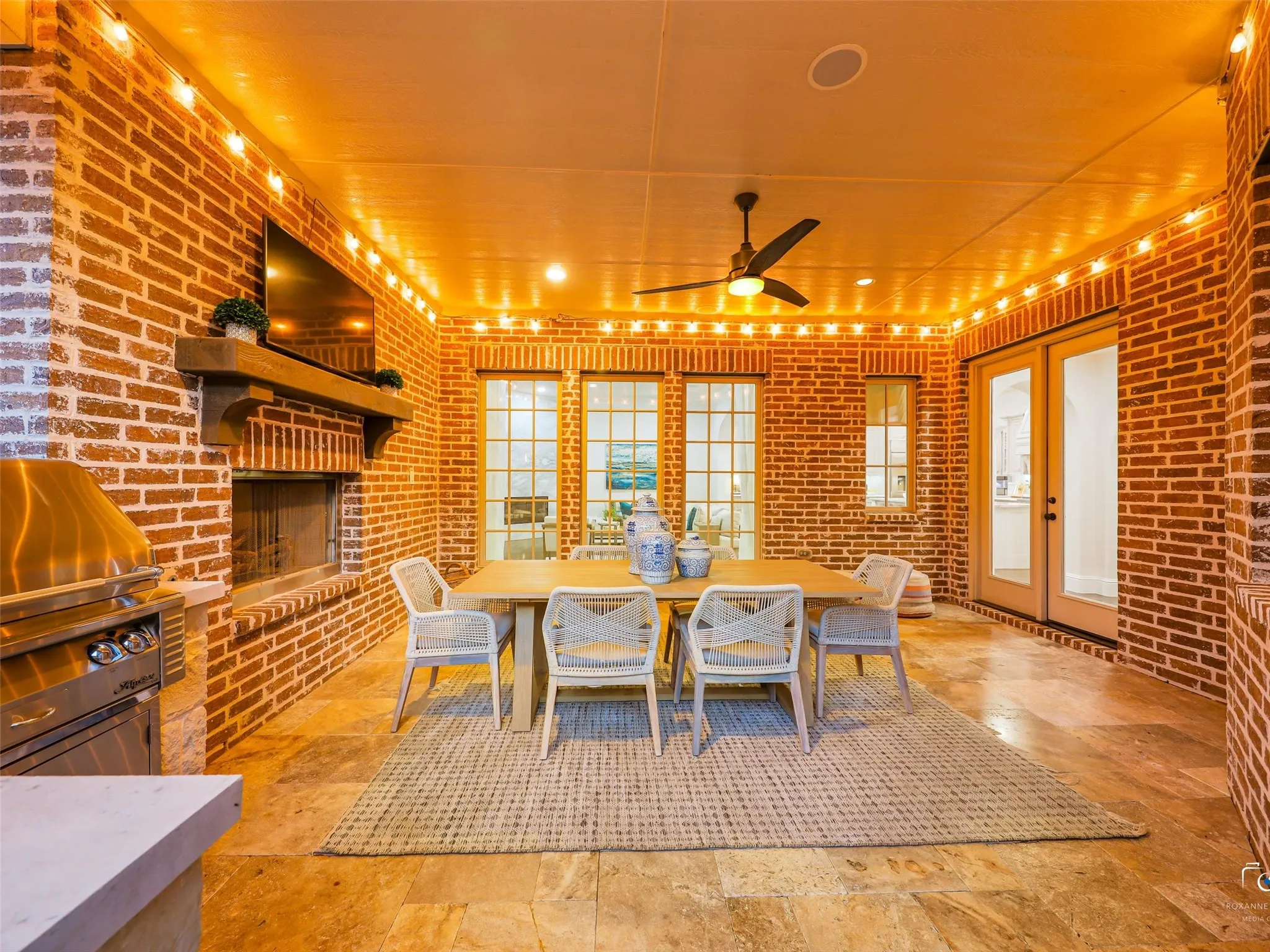 Covered patio with fireplace and outdoor living center