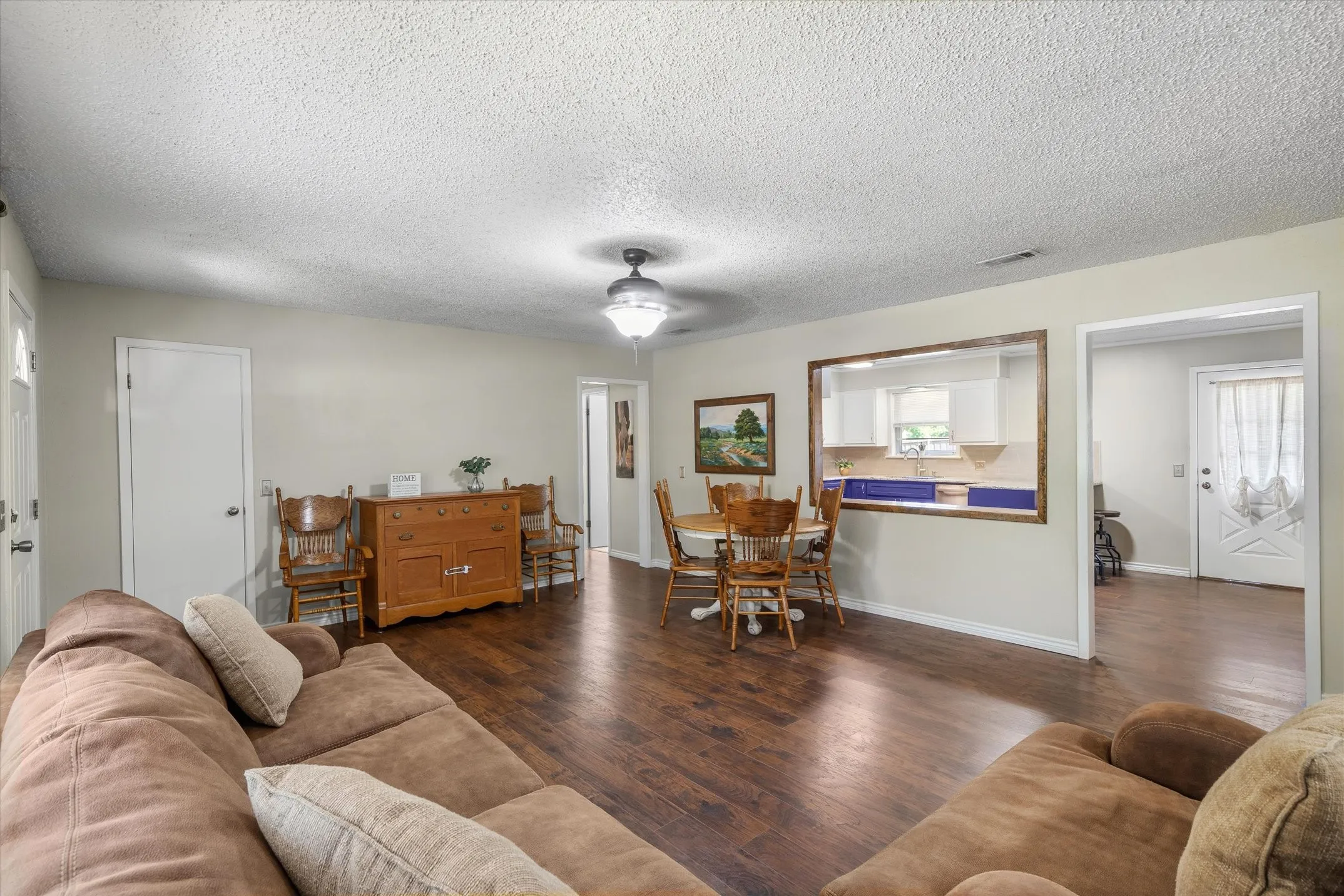 Kitchen dining and living room intertwine for an open concept with MCM charm