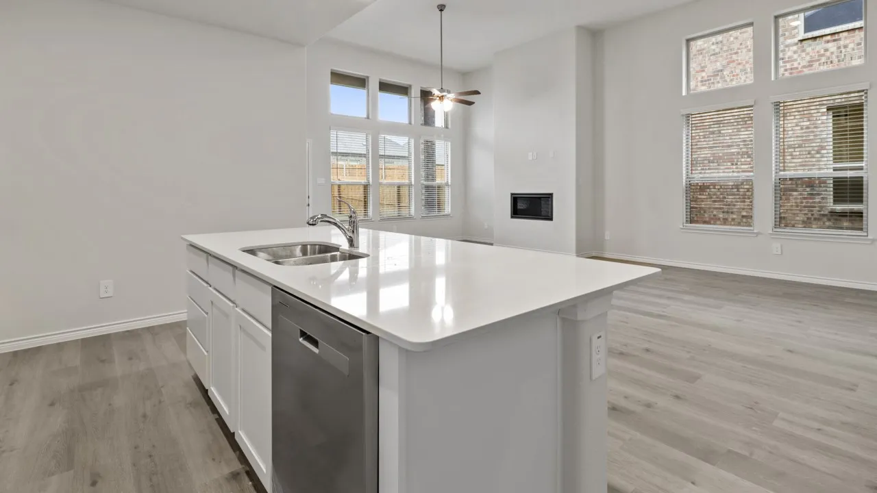Central island featuring a dual basin sink and integrated dishwasher