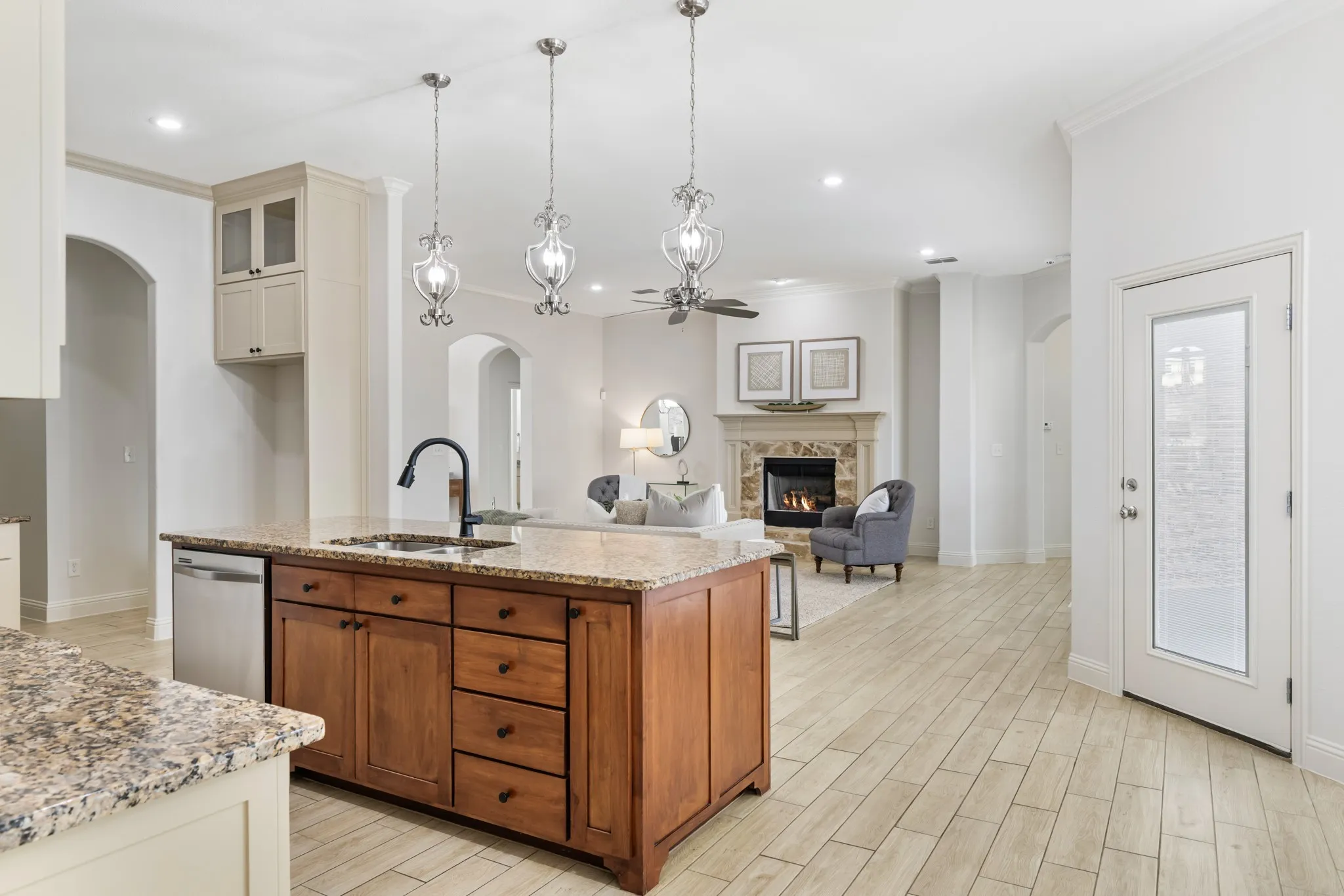 Kitchen island with granite countertop and stainless steel dishwasher